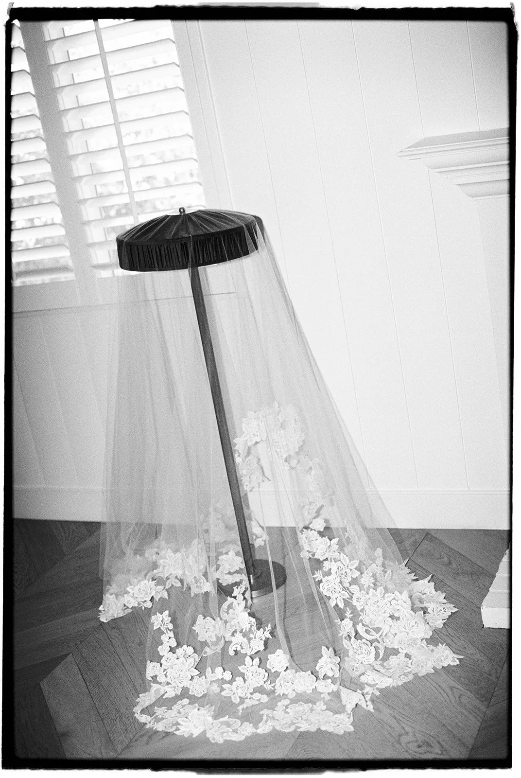  The bride’s flowing veil, detailed with lace appliqué, draped and waiting to be worn. 35 mm film. 