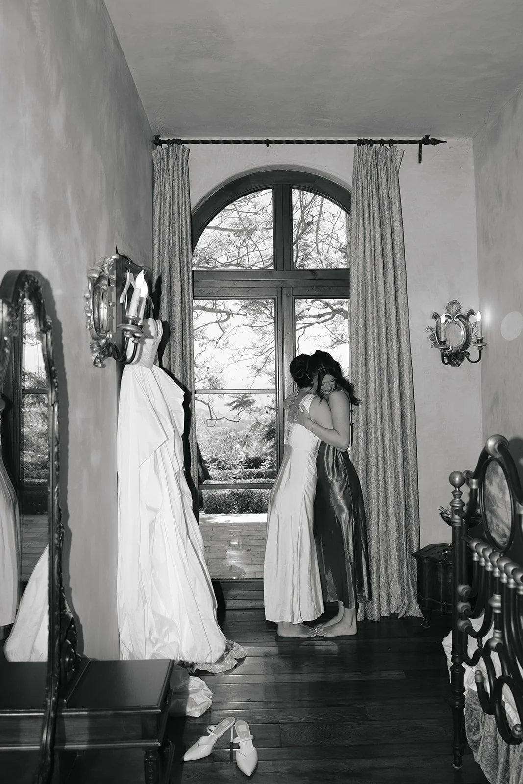 The bride and maid of honor hugging