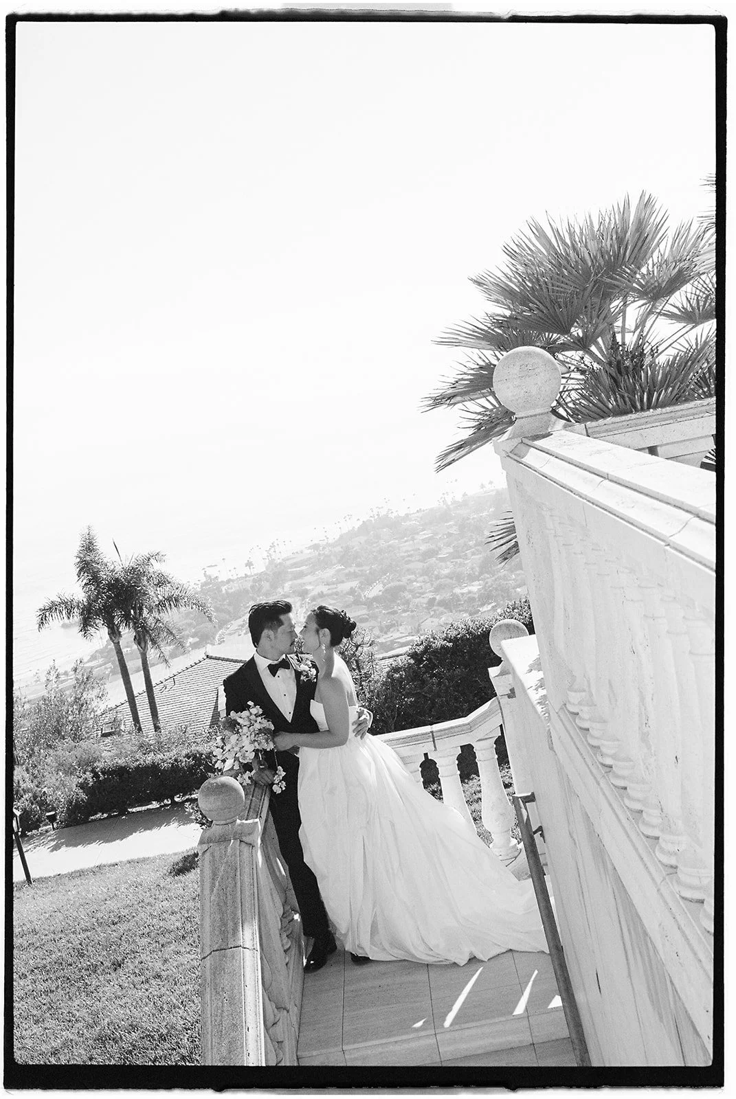 Bride and groom with the ocean behind them