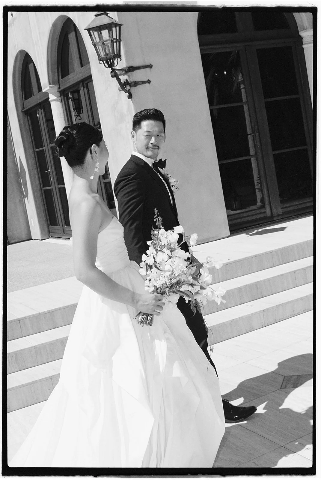 The bride and groom holding hands.