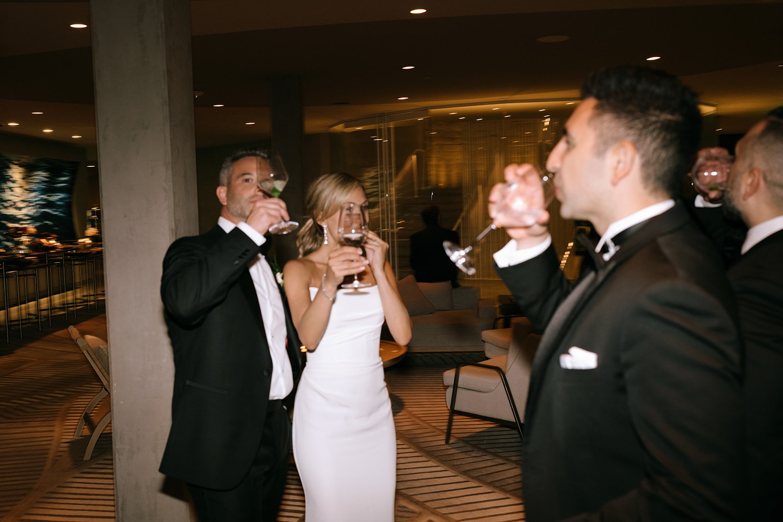 blurry candid wedding photos documentary style drinking with friends bride and groom candids