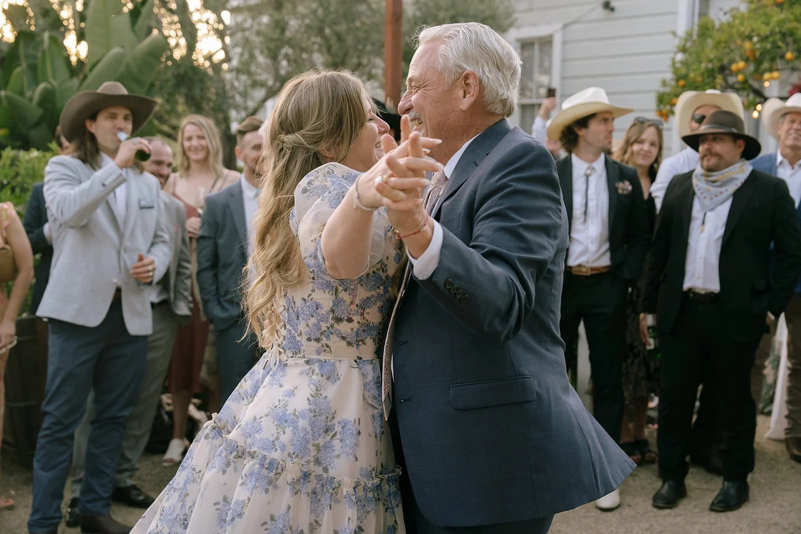 Father-daughter dance with bride and guests watch