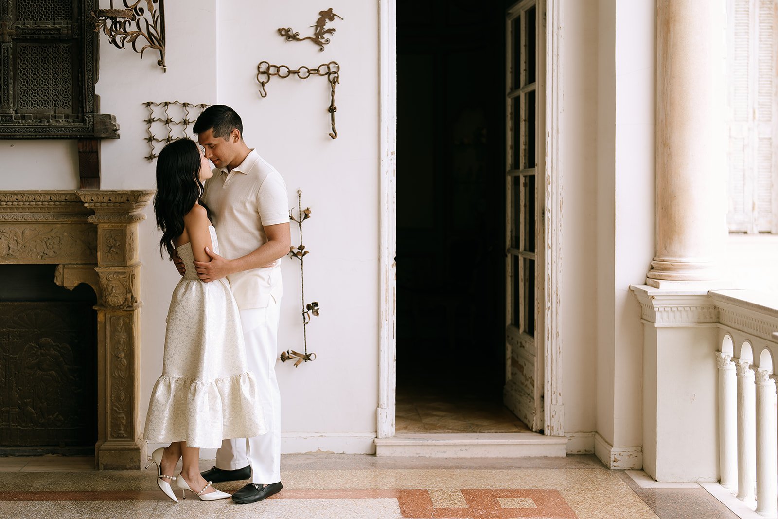 Couple embracing inside the Villa Ephrussi de Rothschild during their destination engagement photoshoot on the South of France