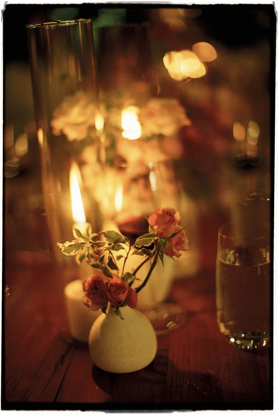  The candlelight illuminates the tablescape in the post-wedding glow. 35 mm film. 