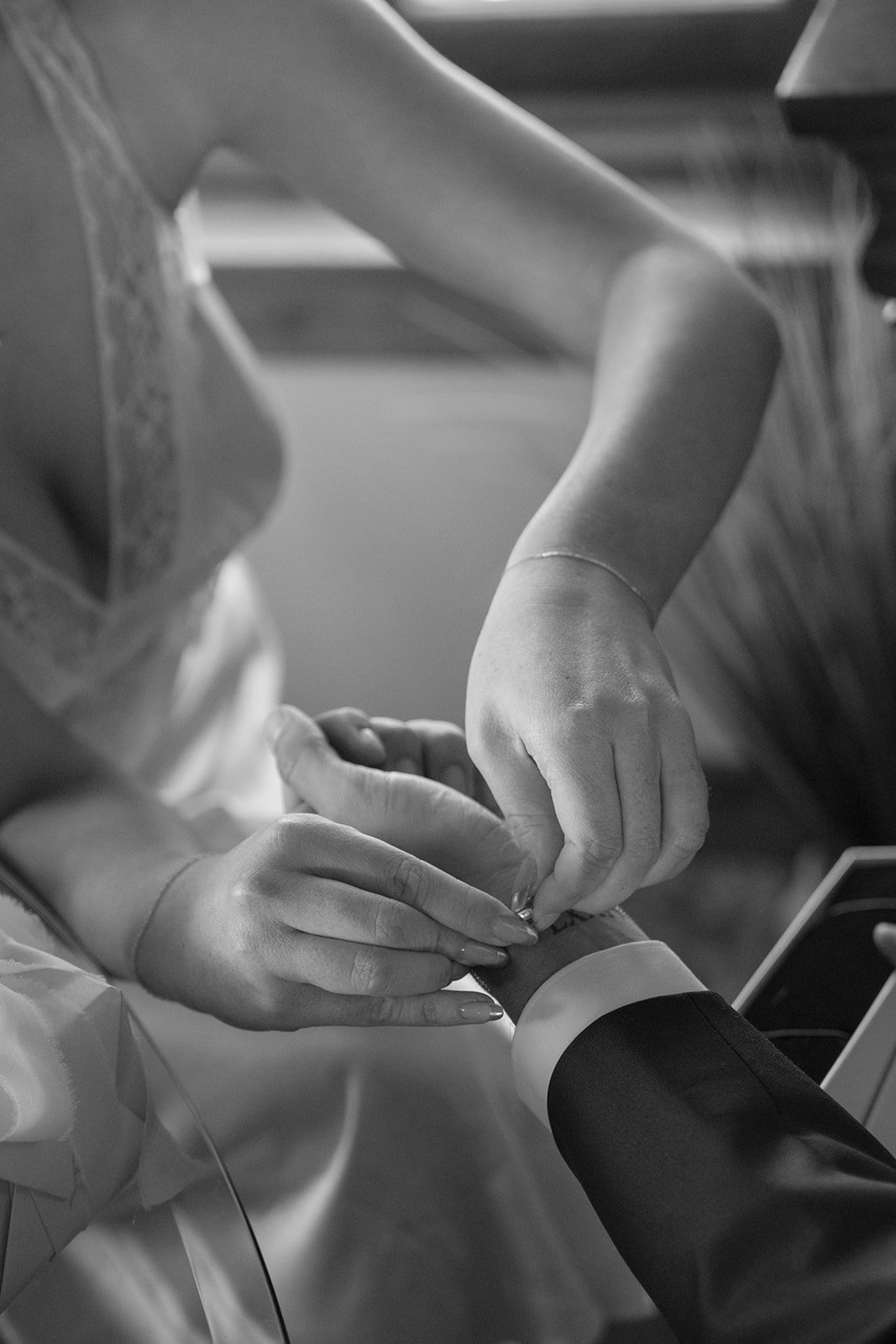 Bride fastens groom's new gold bracelet