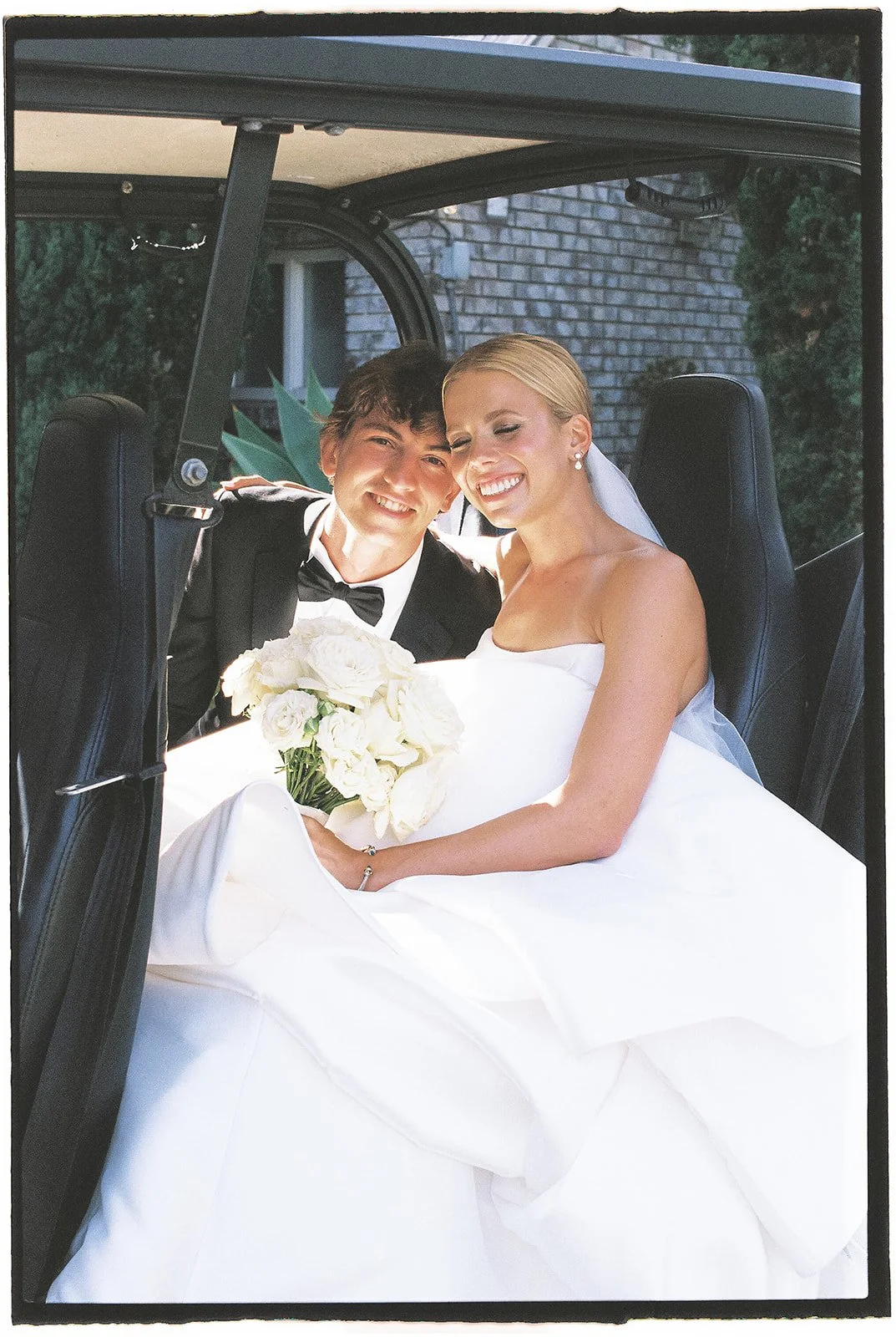 Bride and groom in a golf cart