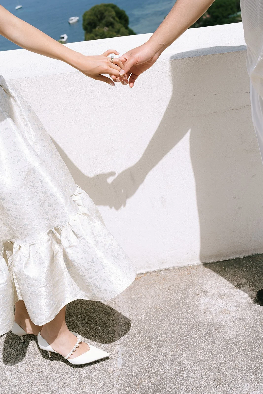 A couple holding hands during a destination engagement session on the South of France