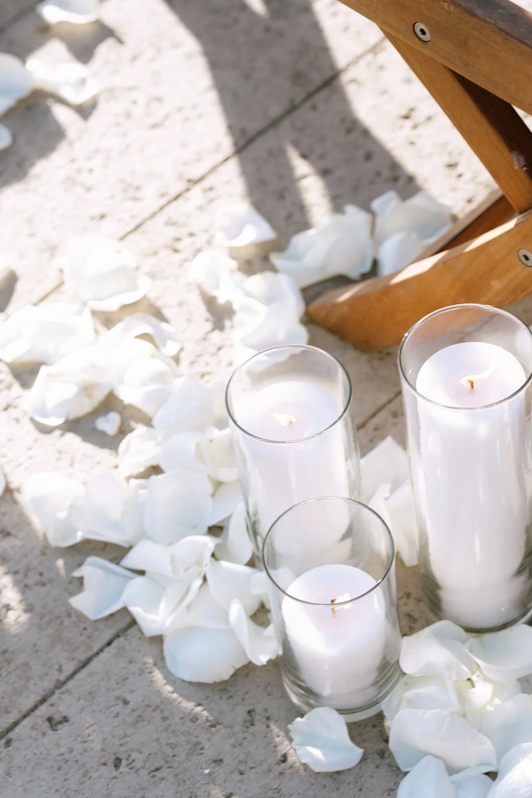 candles and rose flower petals on the ceremony aisle for a wedding