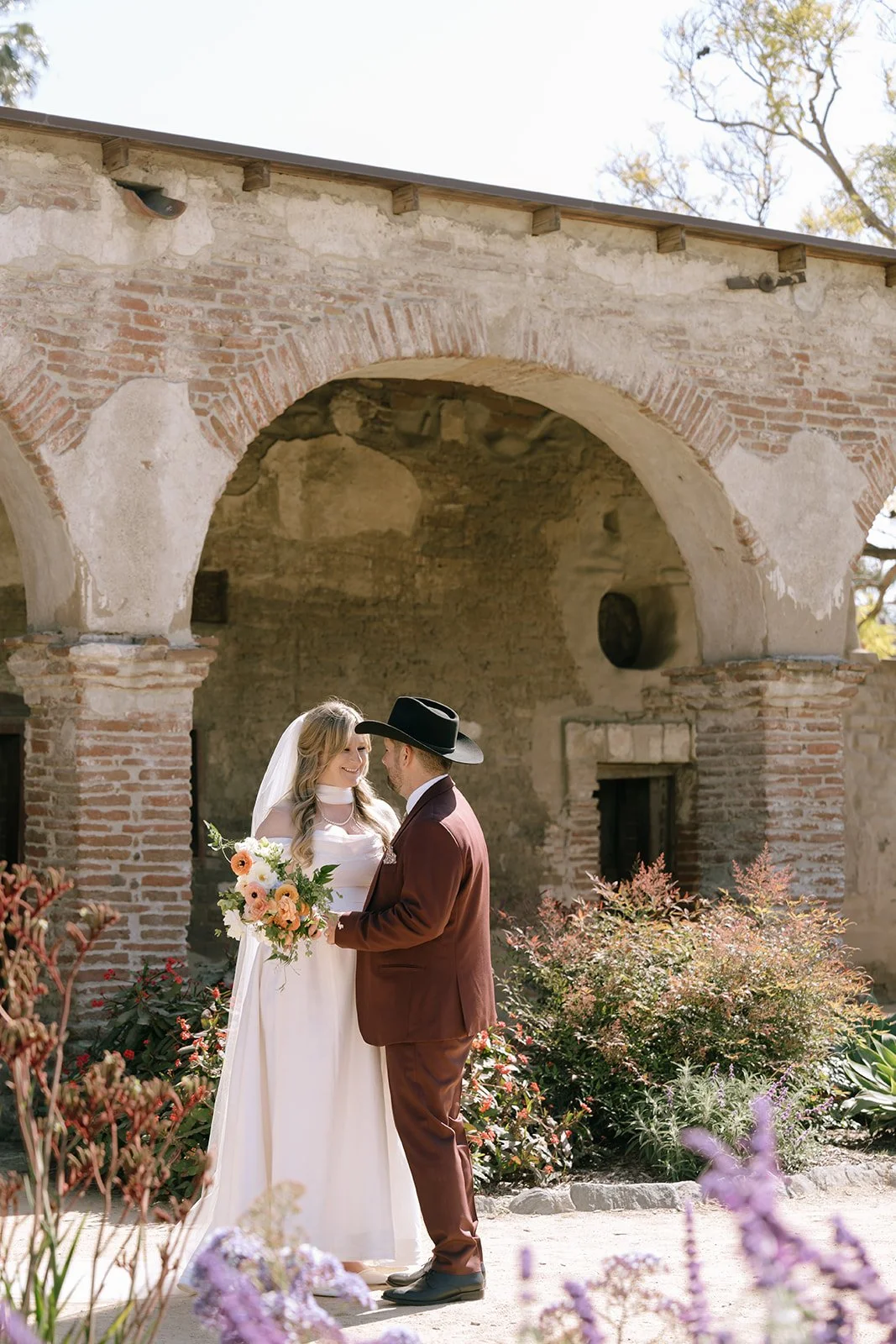The newlyweds having a moment to themselves. Surrounded by historic arches and purple lavender.
