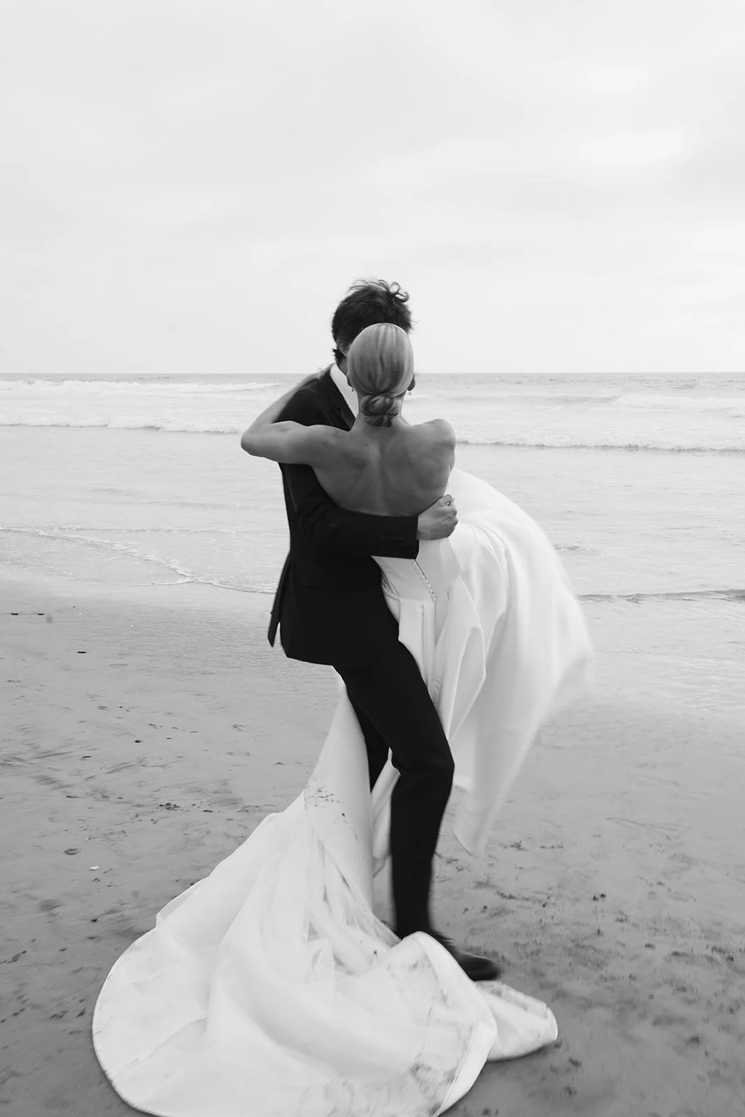 A picture of the groom spinning around with the bride.