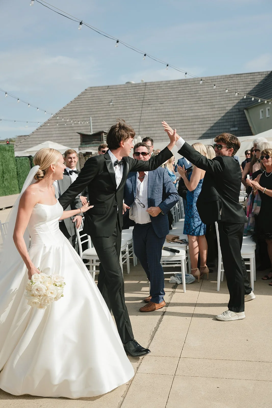 The groom high-fiving a friend
