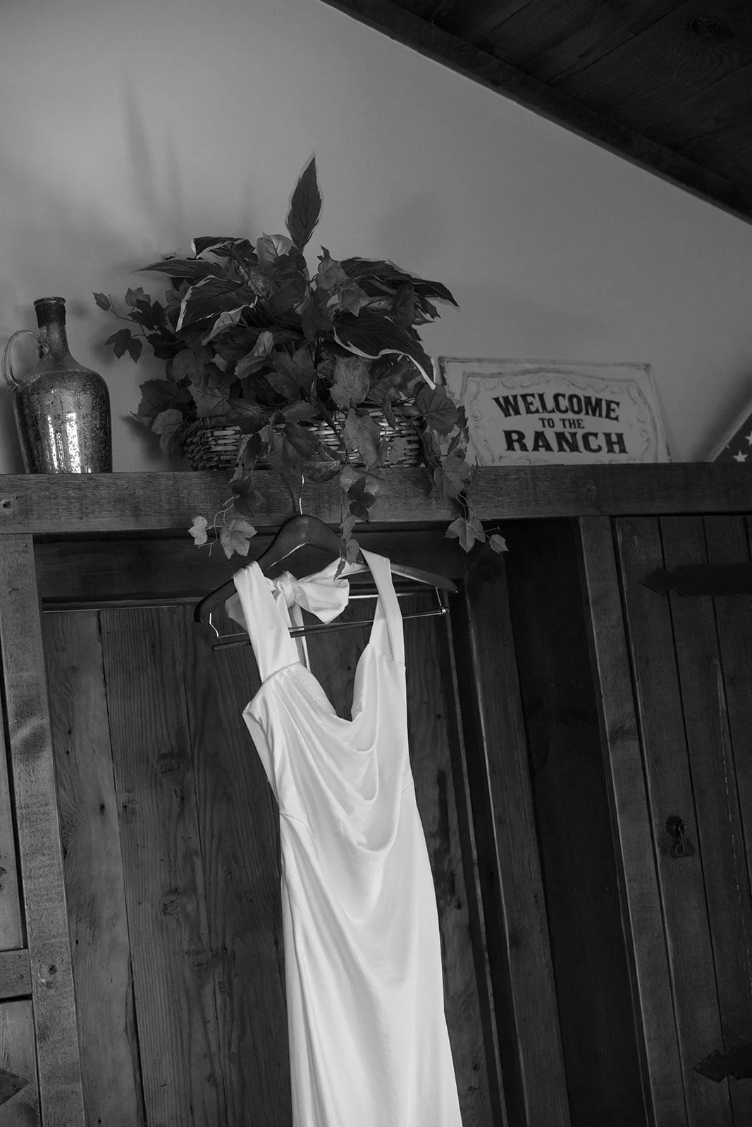 Bridal wedding gown hangs in childhood home.