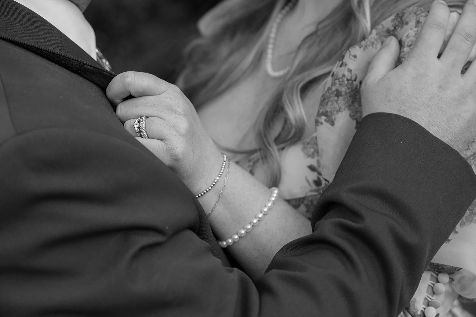 Bride's vintage engagement ring, wedding band, and pearl and gold bracelets