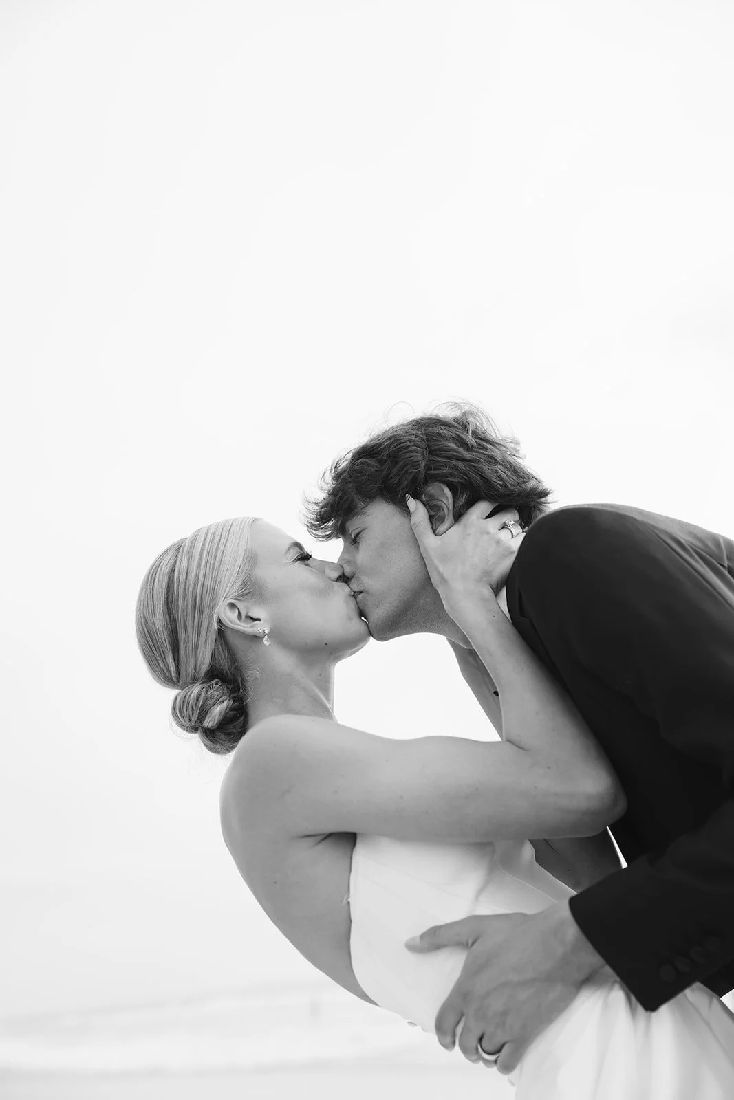 The bride and groom kissing.
