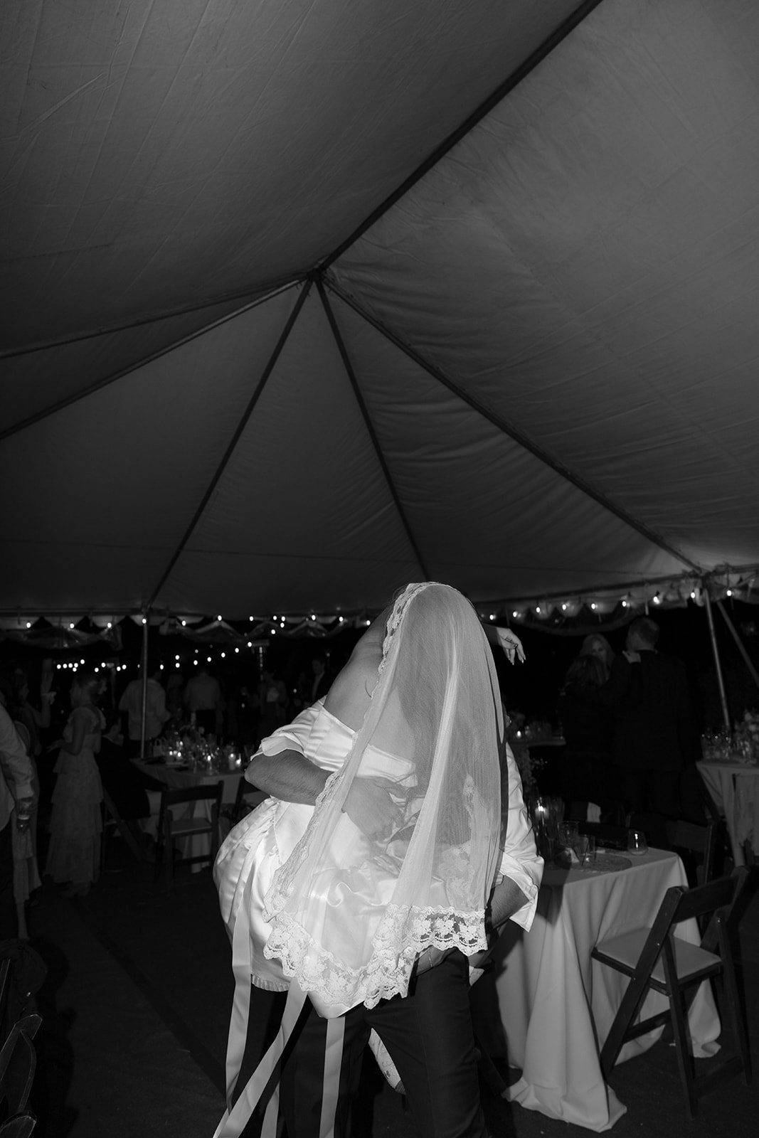 Groom picks up the bride and holds her.