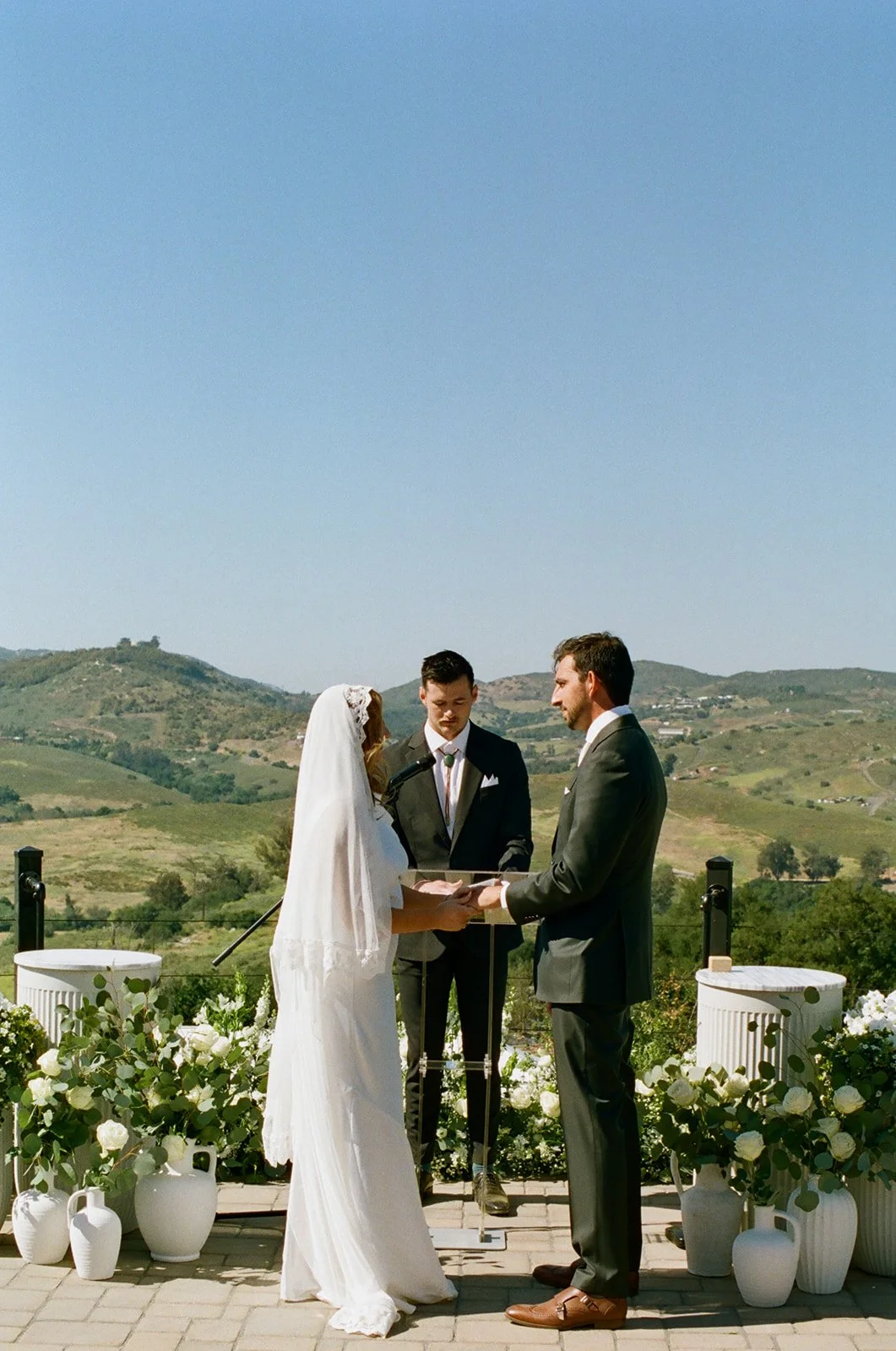 Bride and groom exchange vows on analog 35 mm film.
