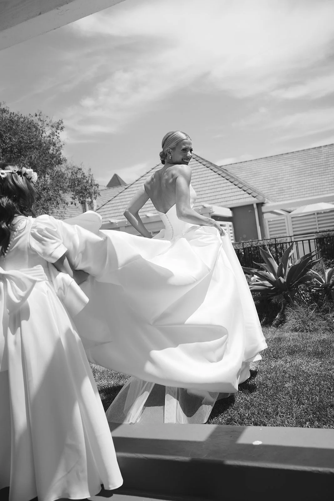 The flower girls holding the train of the bride’s gown.