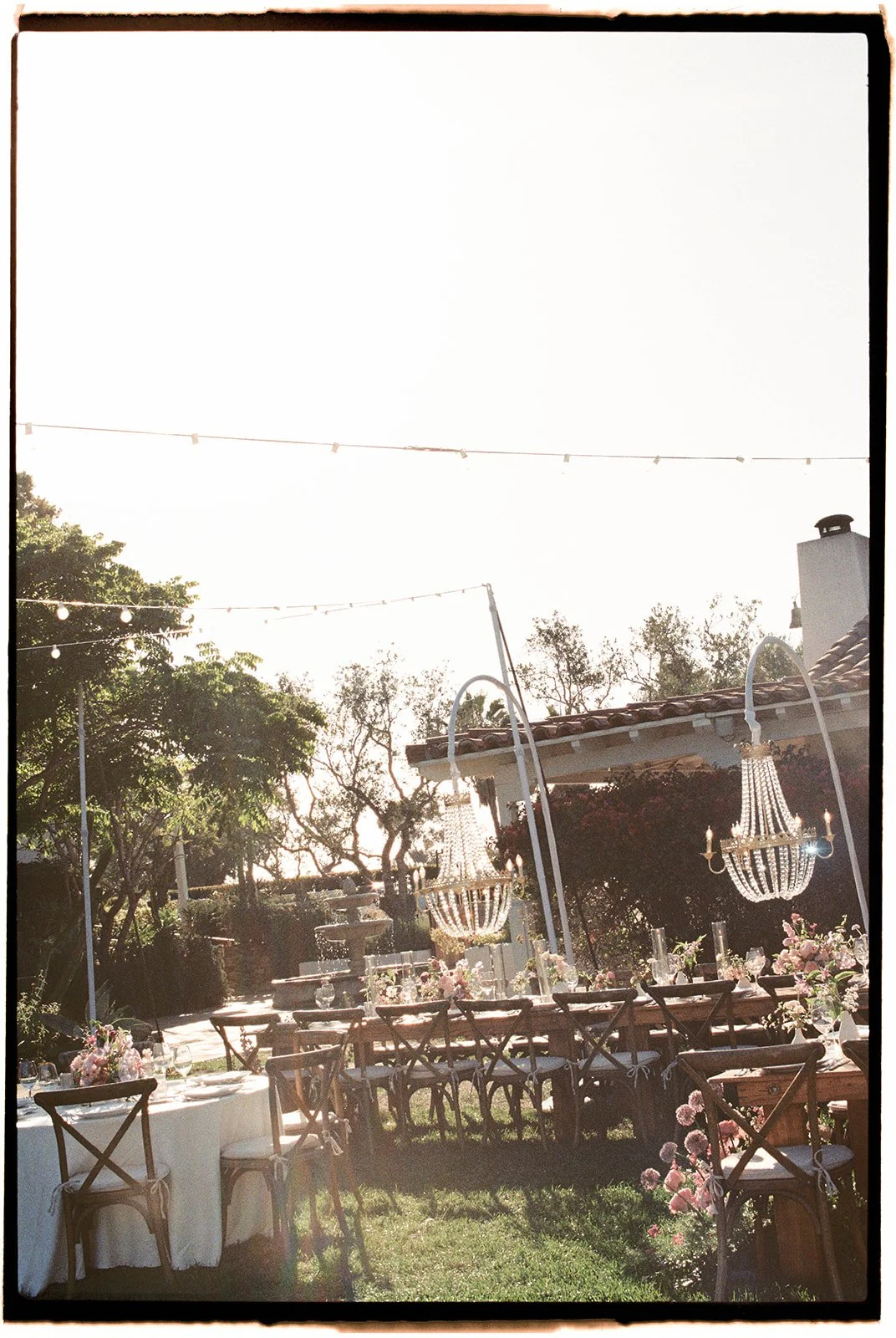  The sun gleans through the chandeliers creating a dreamy atmosphere for this backyard wedding. 