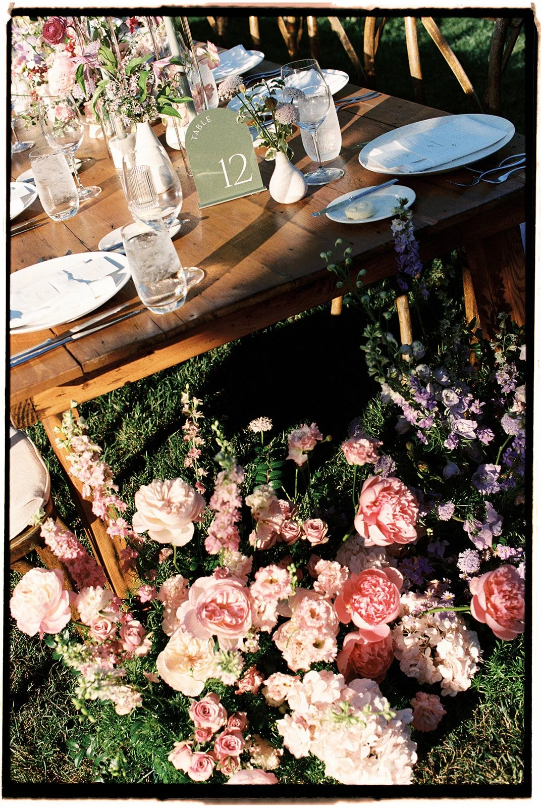  A floral arrangement at the head of the table adorned with peonies and roses. 35 mm film. 