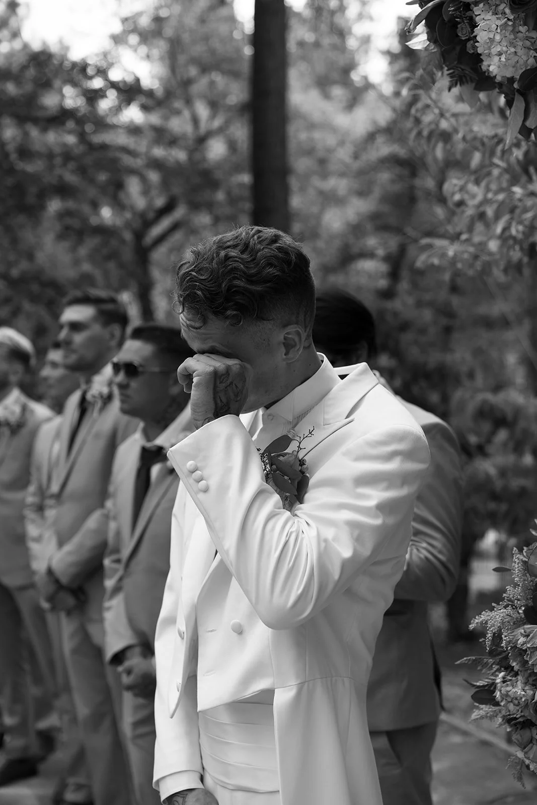 Groom wipes away a tear at the sight of his bride walking down the aisle at their wedding ceremony in Big Bear California