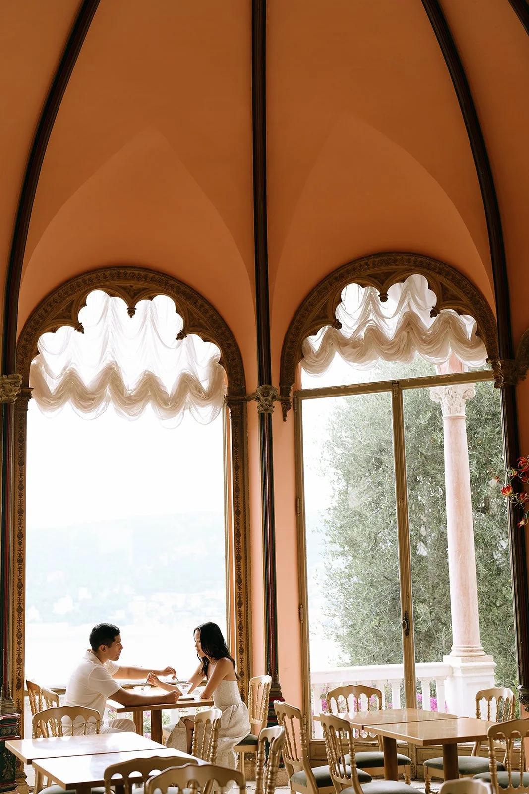The soon to be bride and groom stop for ice cream in the Tea Room Beatrice of the Villa Ephrussi during their destination engagement photoshoot on the South of France