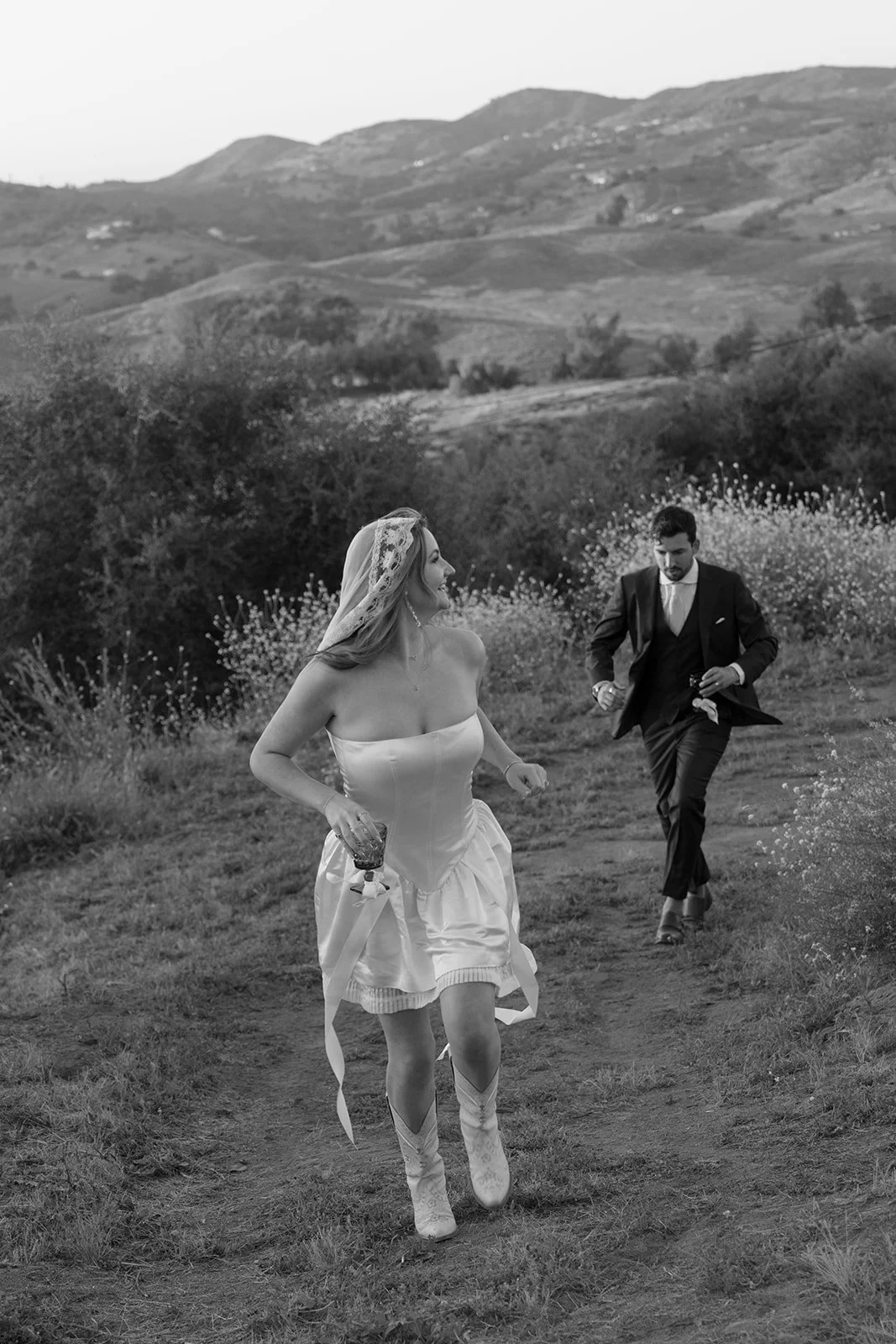Bride and groom running off to sunset portraits.
