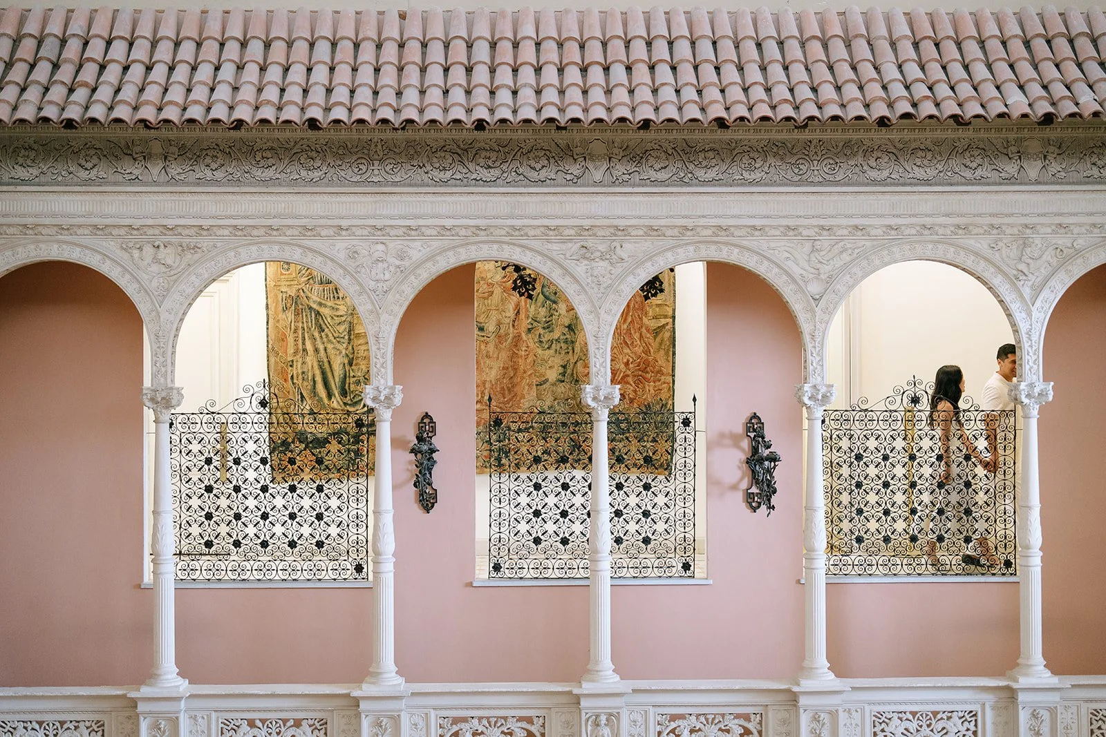 The soon to be bride and groom are seen through the wrought iron details of the windows of the Villa Ephrussi on the South of France
