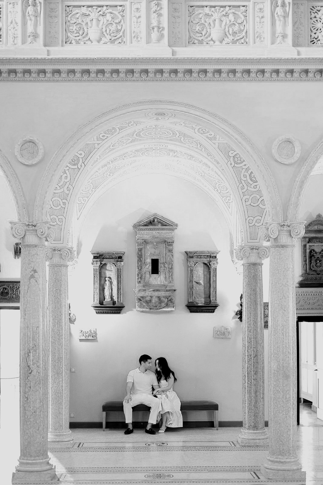 The soon to be bride and groom sitting together on a bench inside the Central Atrium of the Villa Ephrussi de Rothschild designed in the style of the Italian Renaissance