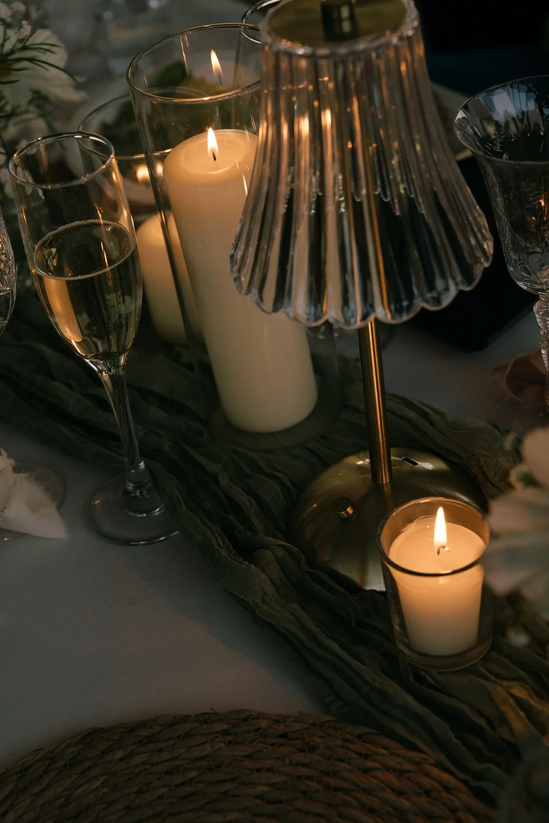 Reception details: Crystal table lamps, champagne glasses, and tea light candles