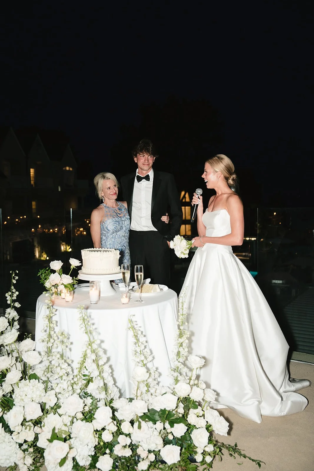 The bride giving a toast by the cake.