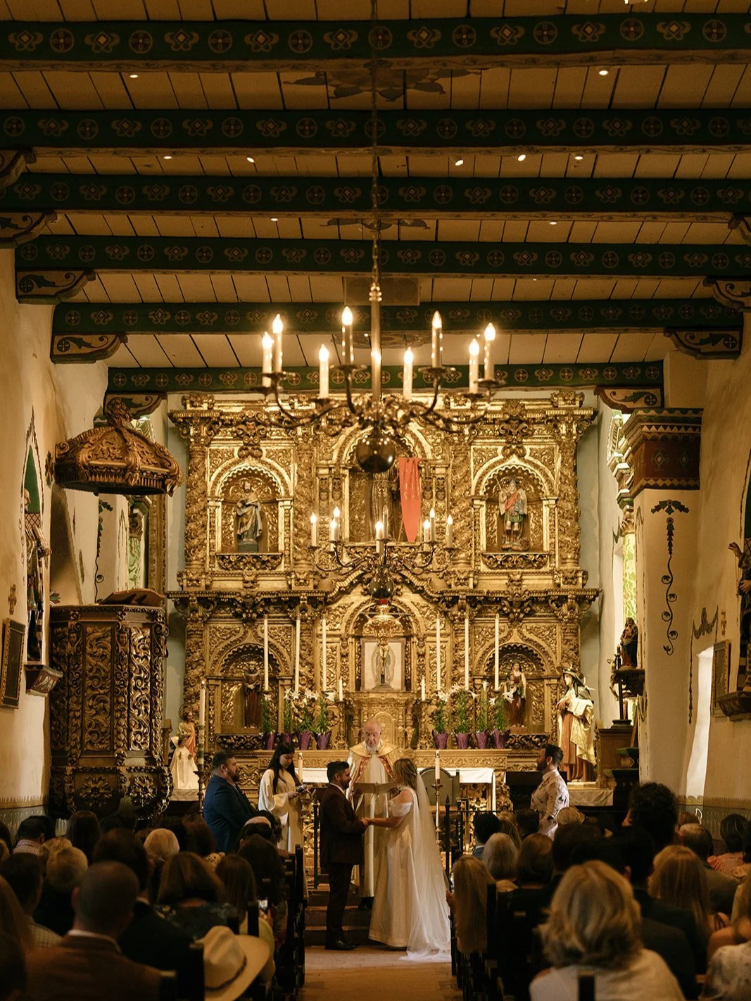 The inside of the historic Serra Chapel, lots of gold details