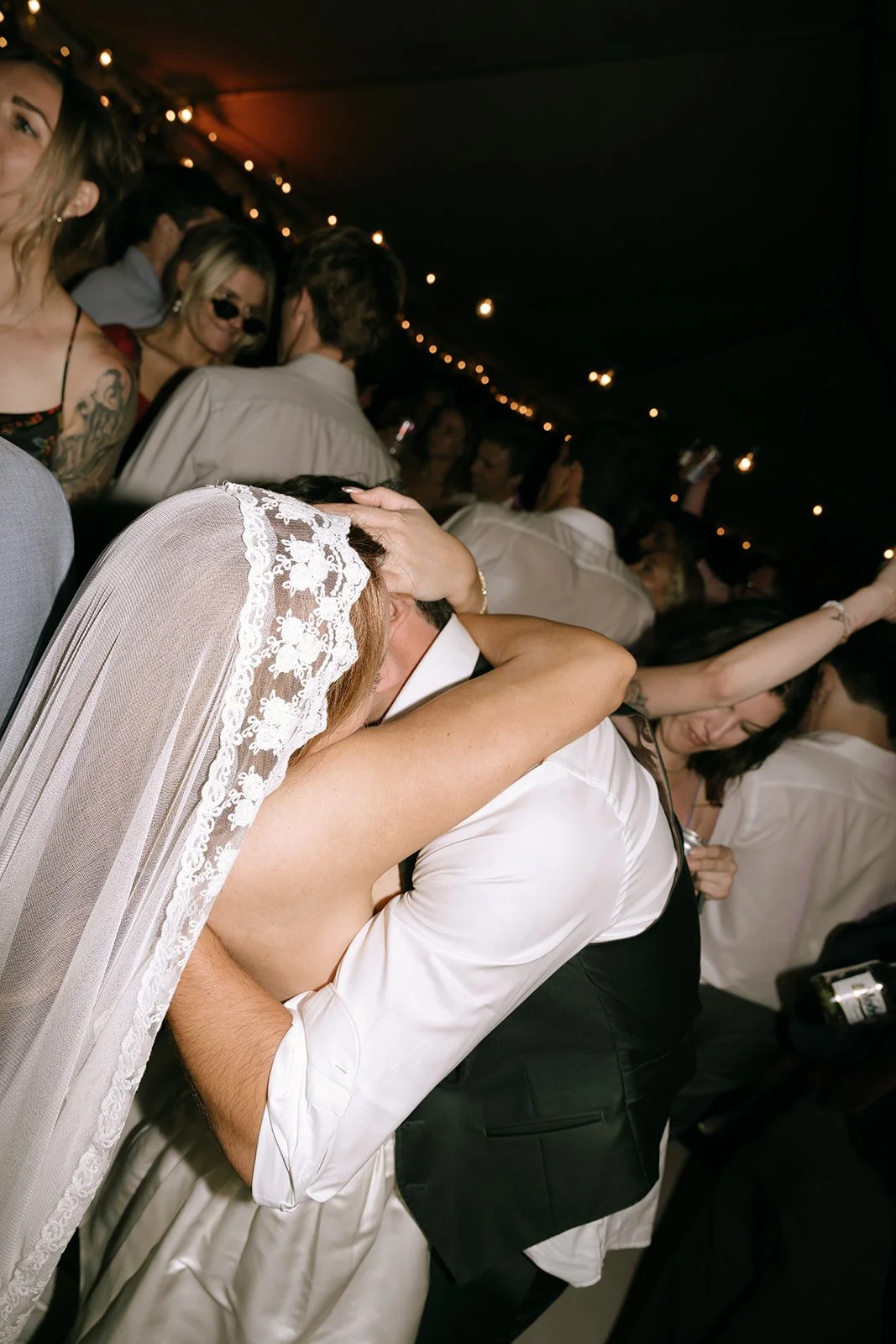 Bride and groom newlywed couple embraces. Mantilla veil
