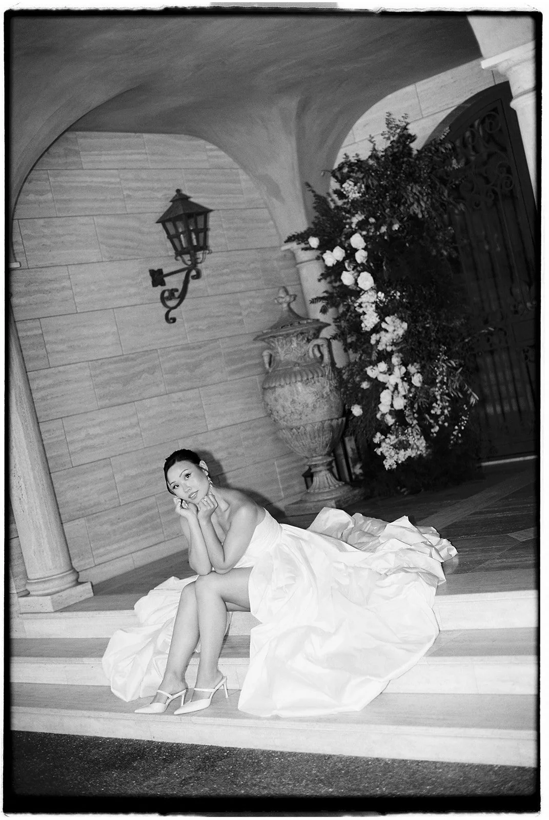 The bride sitting on the stairs of the entryway