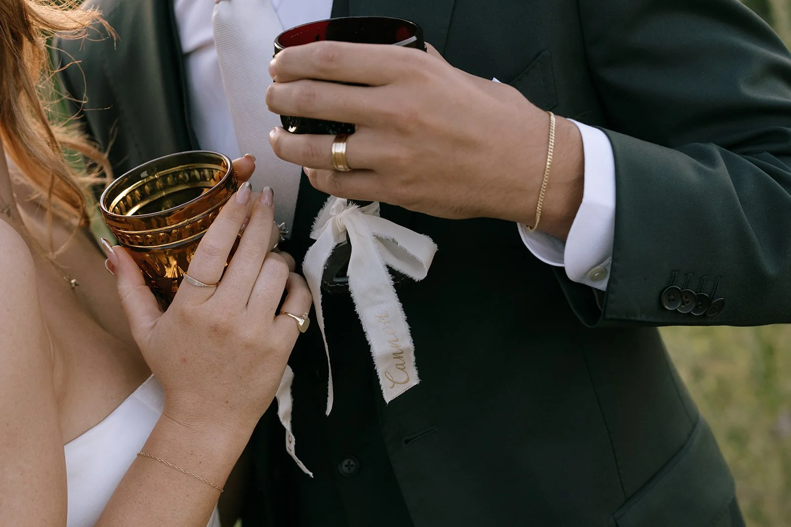Wedding jewelry gifts, colored crystal goblets, and custom place setting ribbons-- reception trends.