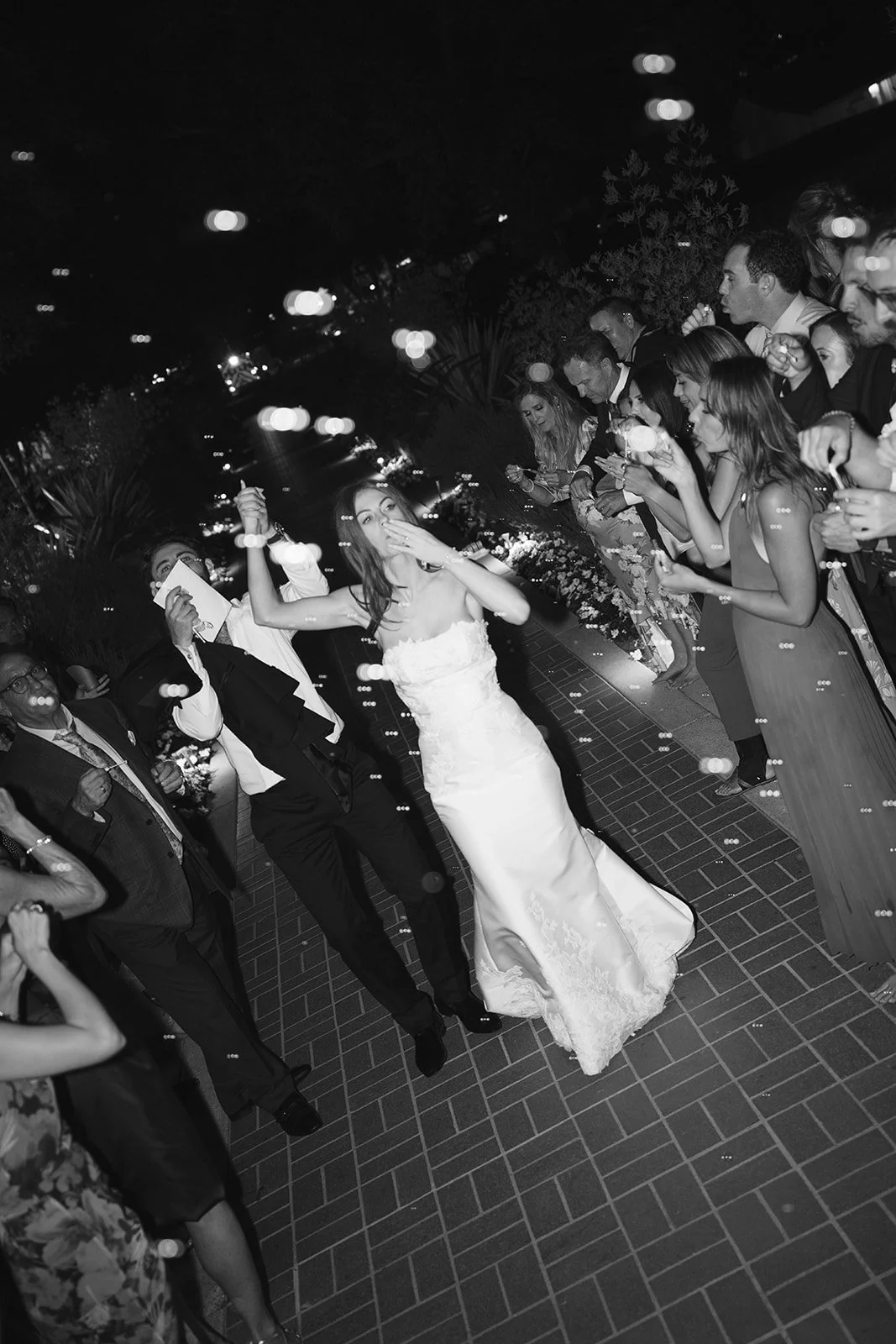  Grand exit: The wedding guests blow bubbles as they send off the bride and groom. 
