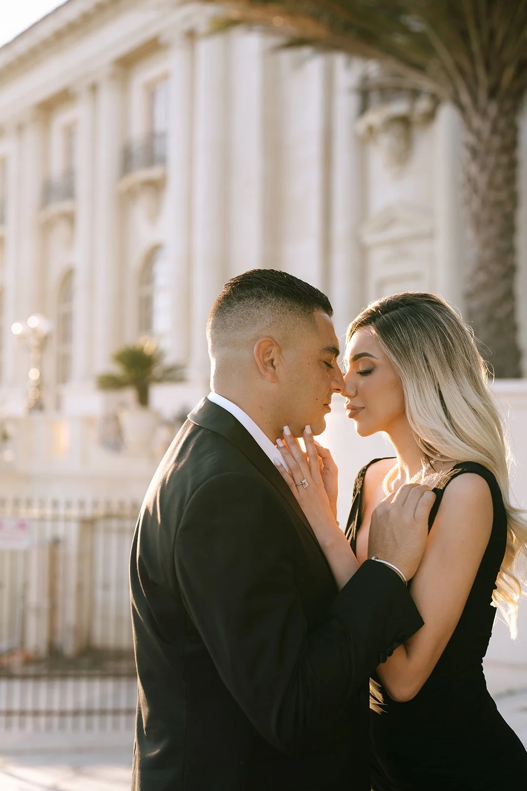 A couple in an embrace with the sun beaming down on them.