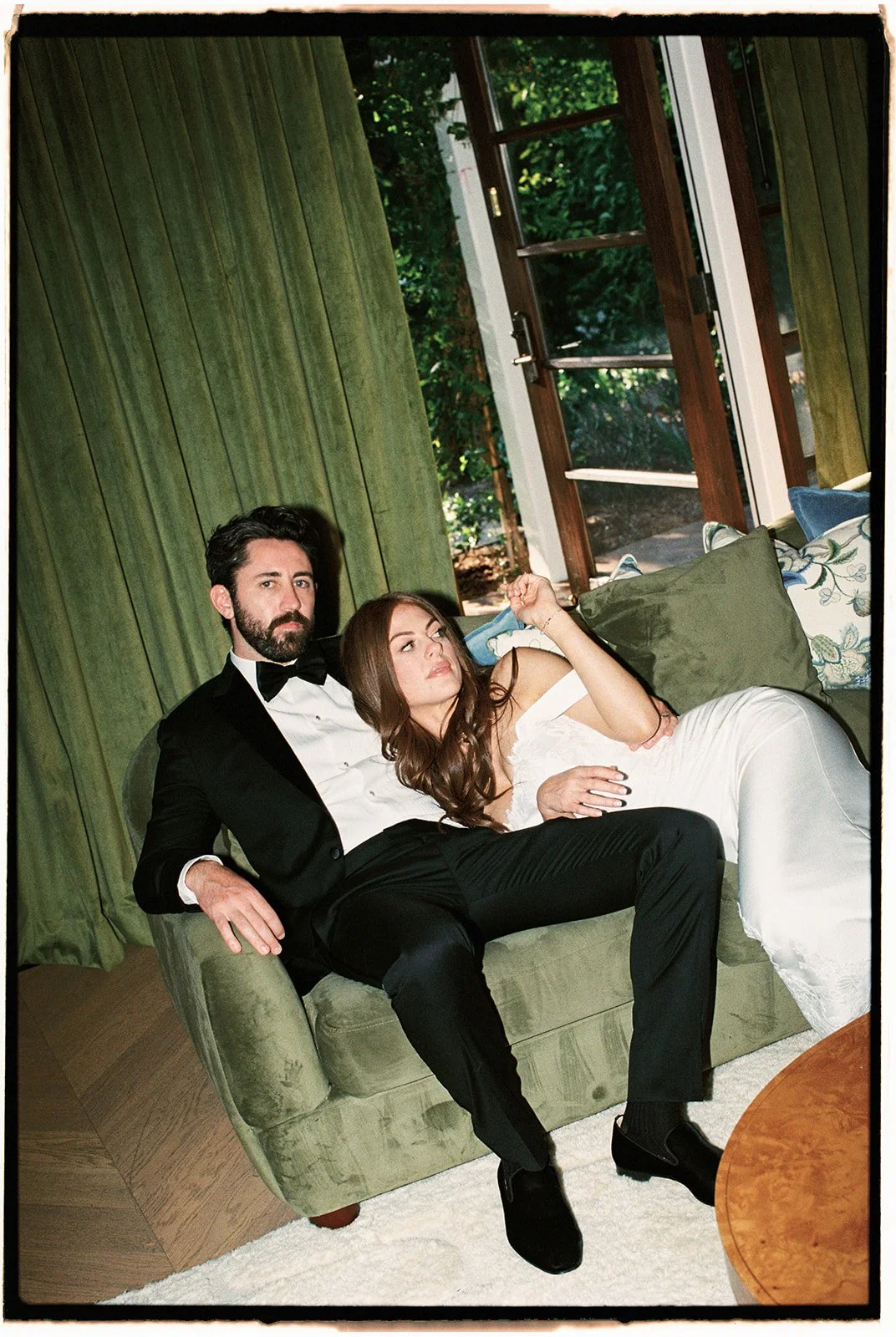  A relaxing editorial moment for the bride and groom before returning to the party. 35 mm film. 