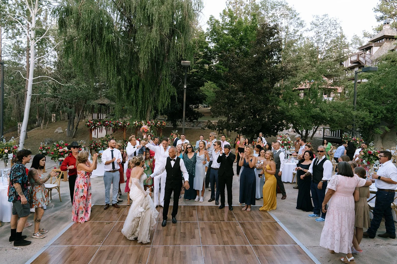 Bride dances with her father on the dance floor at the outside wedding reception in Big Bear California