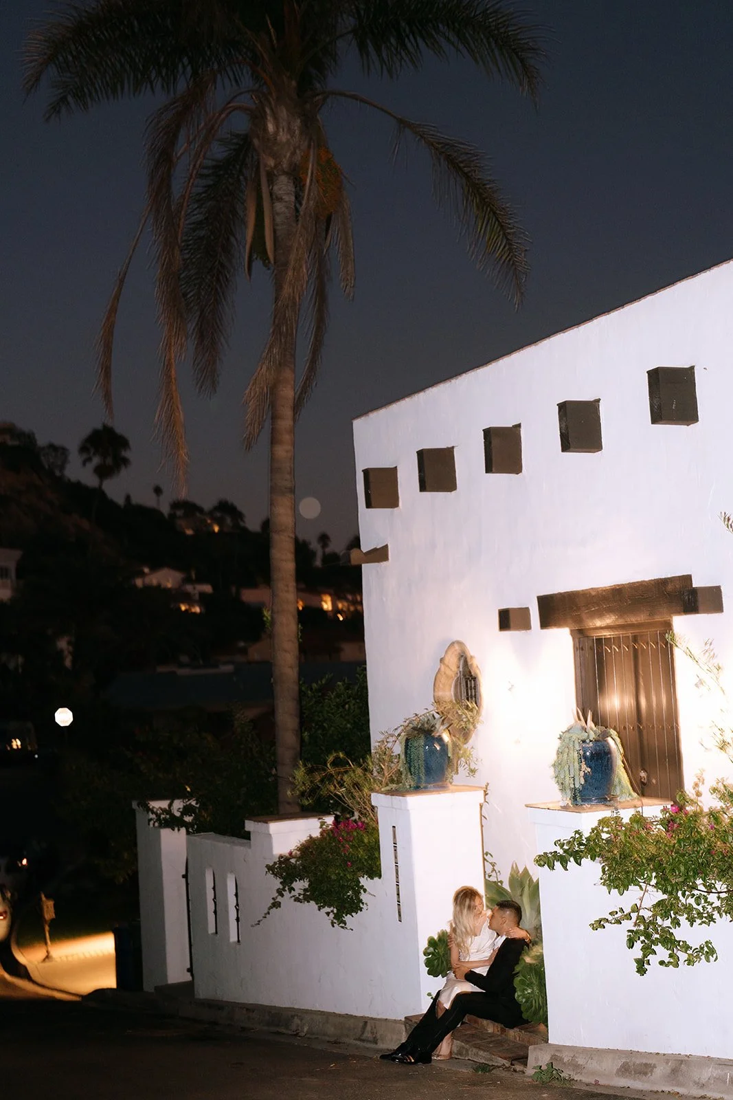 A blurry photo of the couple sitting on the stairs of the villa