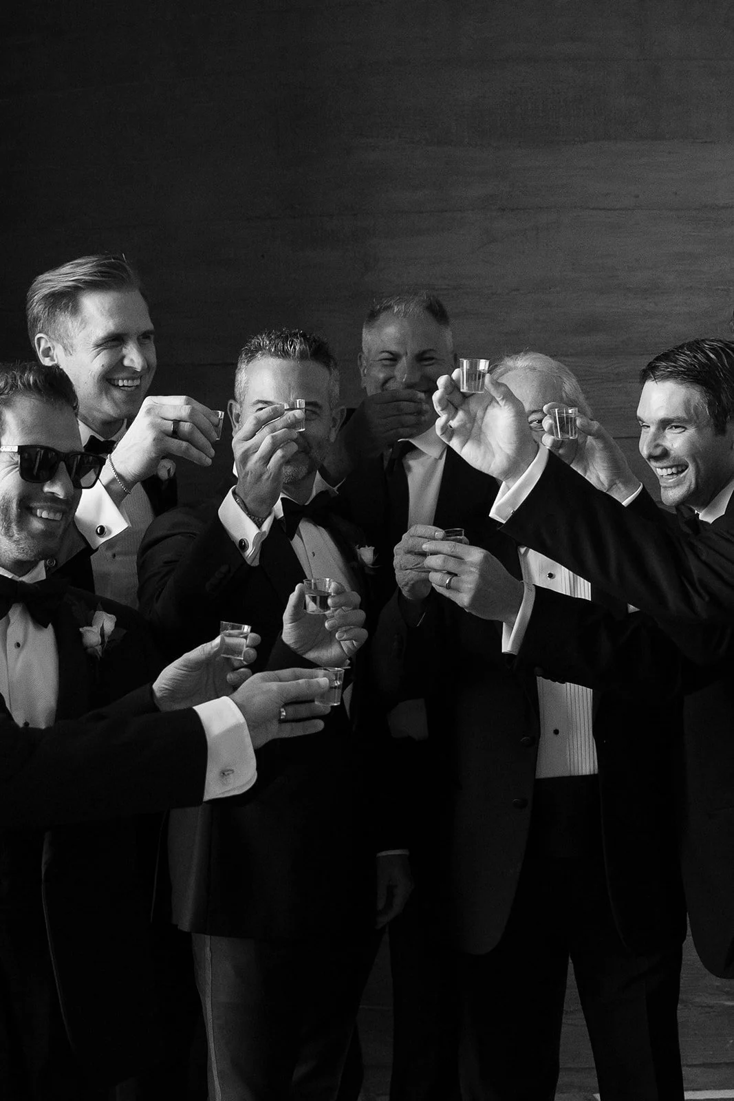 a toast with the groomsmen in black and white shots
