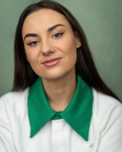 Jade Franks photo. Jade smiling calmly wearing a whist shirt with a green collar