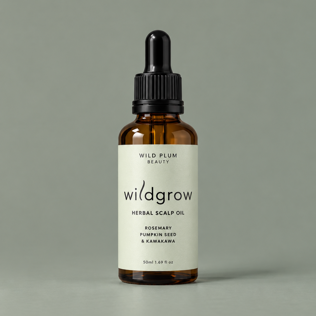 Wild Plum Beauty Wildgrow Herbal Scalp Oil with rosemary, pumpkin seed and kawakawa in an amber glass dropper bottle with a sage green label.