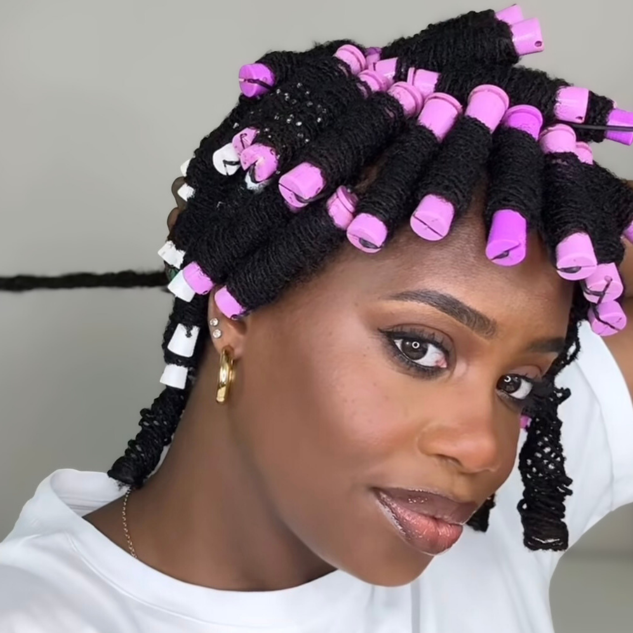 woman with microlocs and perm rod curls