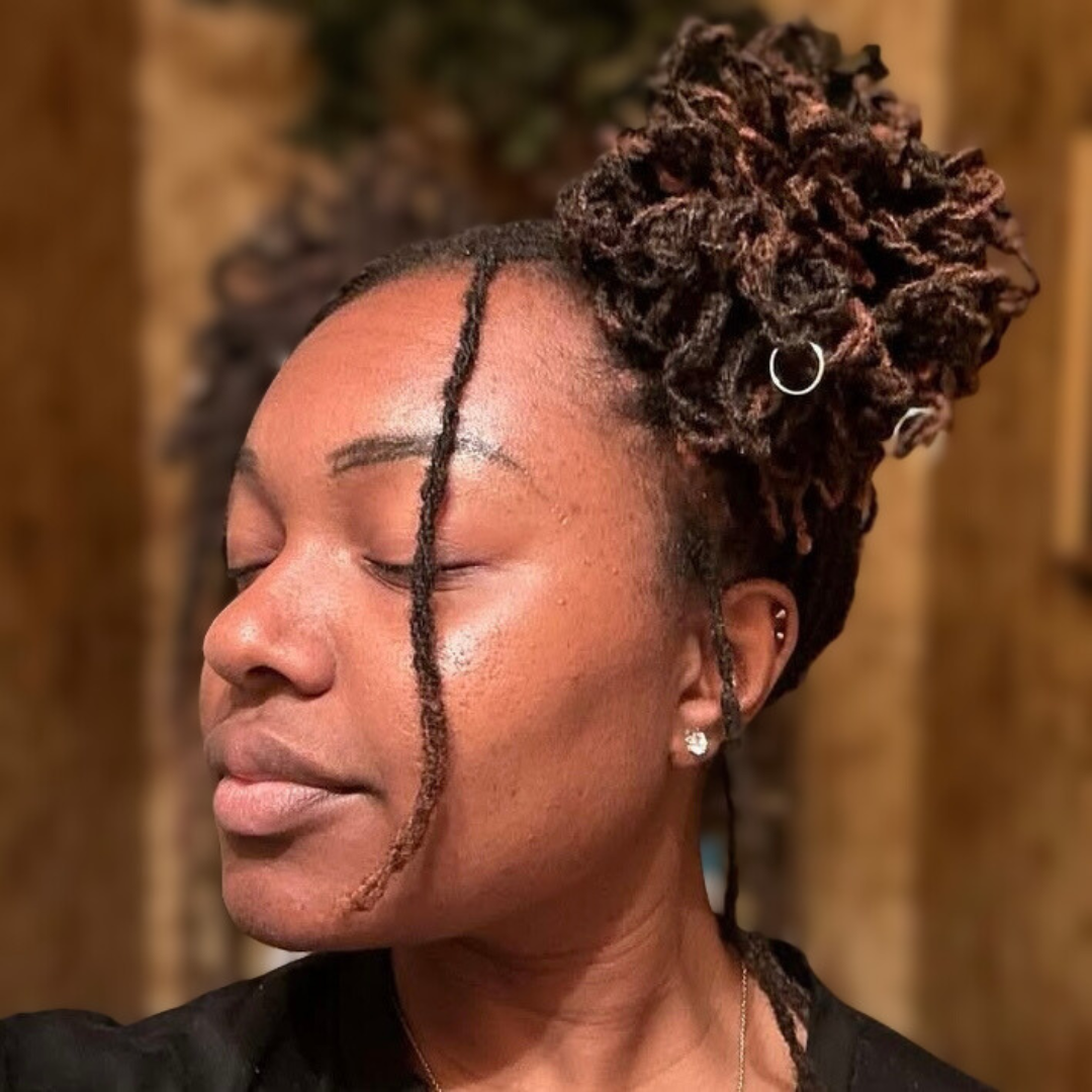 woman with microlocs and curly double high buns