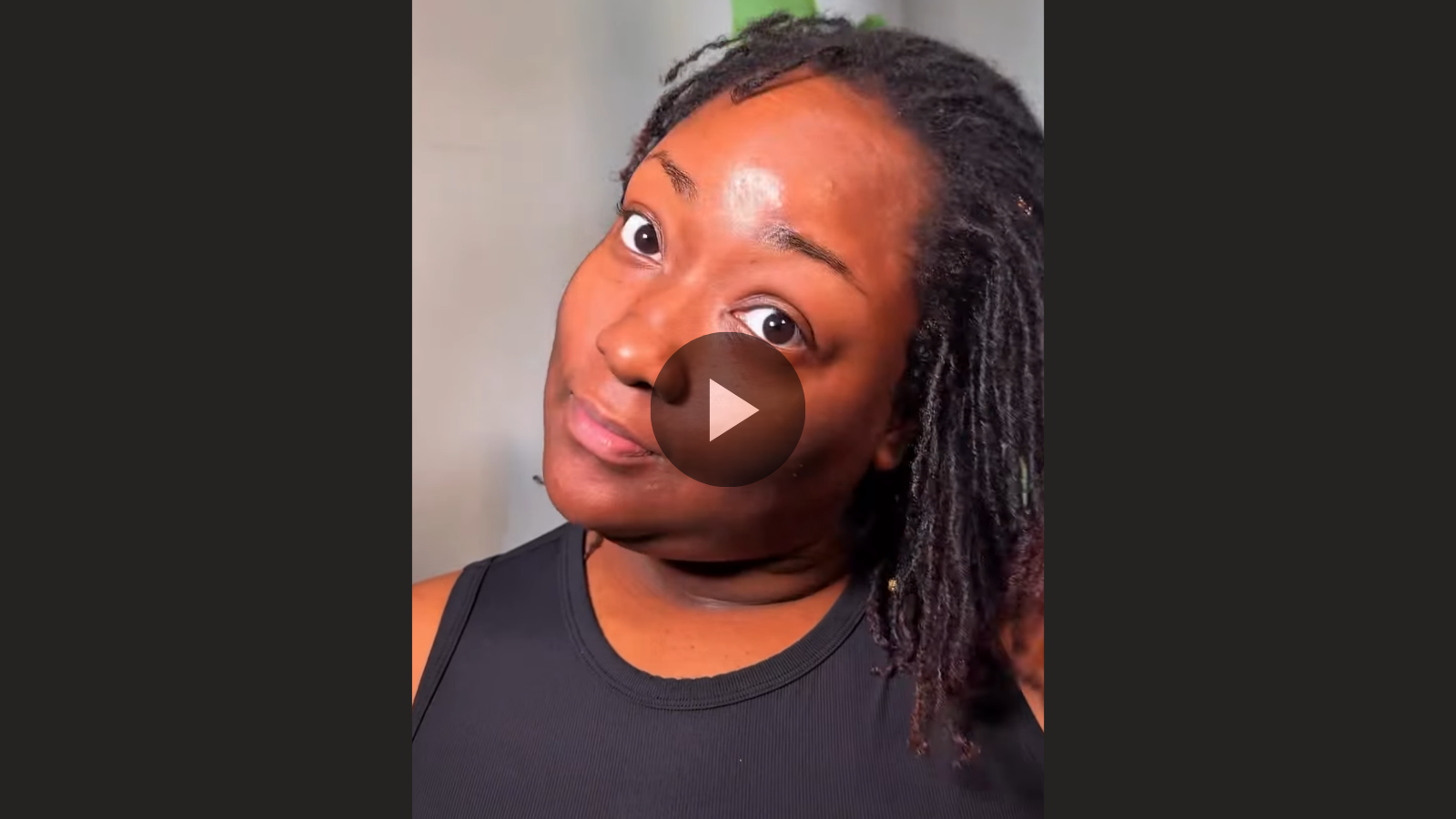 woman with microlocs and flat twist bun updo