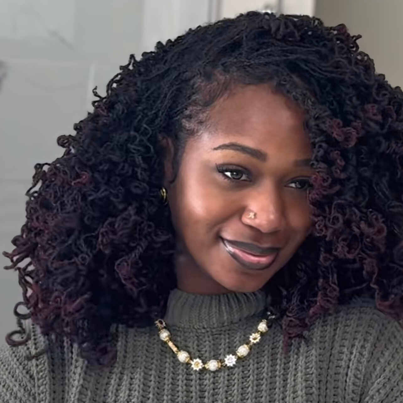 woman with microlocs and barrel curls
