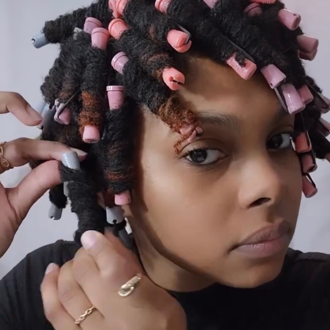 woman with microlocs and perm rods