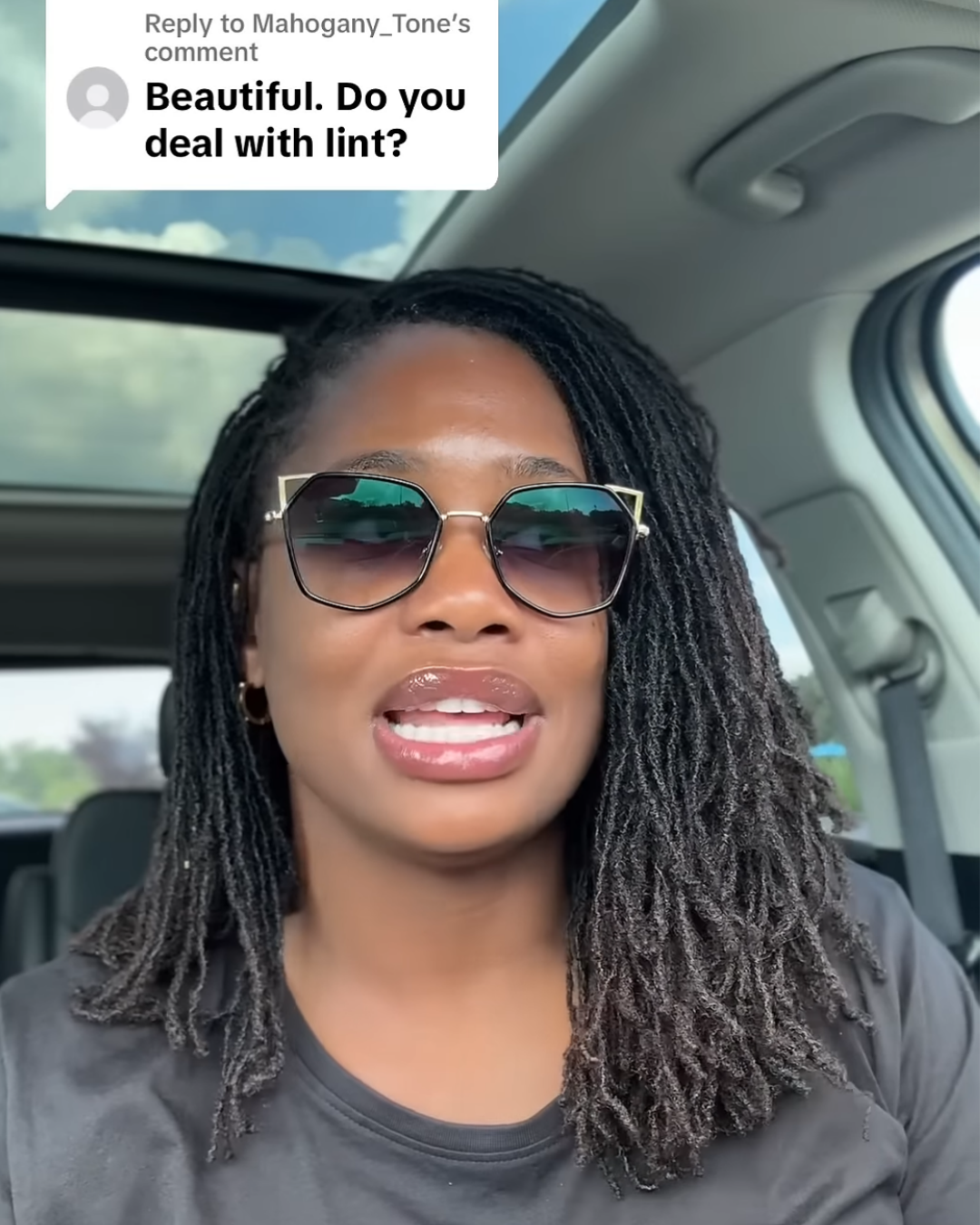 woman with microlocs managing lint