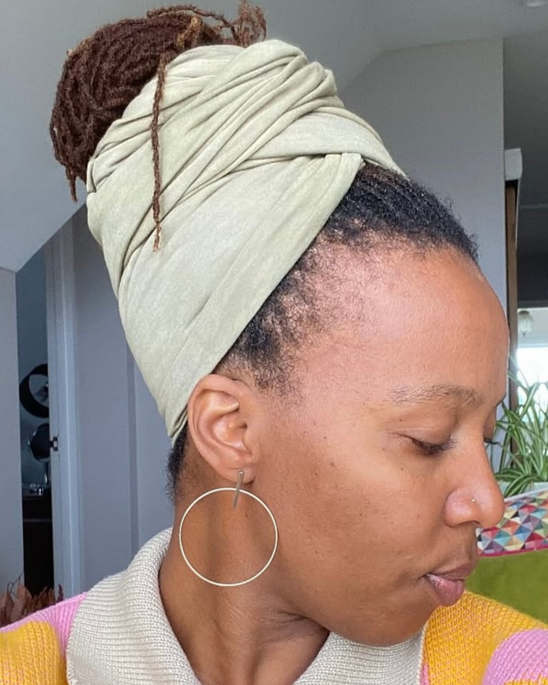 woman with microlocs managing lint