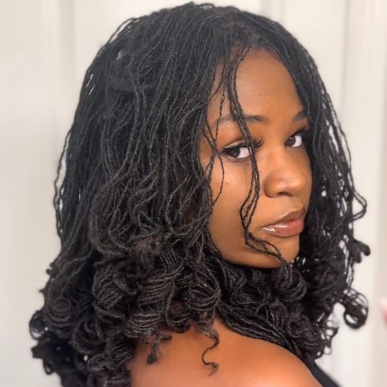 woman with microlocs and soft roller curls